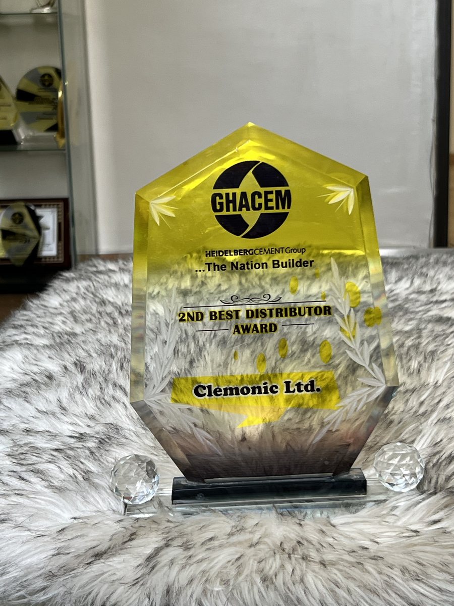 Hexagonal yellow crystal plaque: GHACEM 2nd Best Distributor Award, presented to Clemonic Ltd.