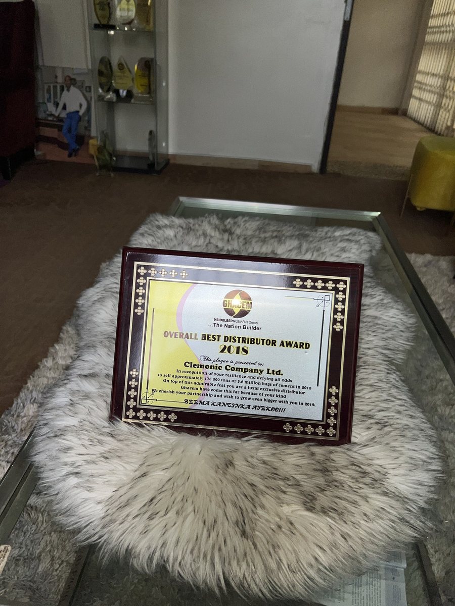 Wooden plaque: GHACEM Overall Best Distributor Award 2018, presented to Clemonic Company Ltd in recognition of selling approximately 178,000 tons, or 3.6 million bags, of cement in 2018