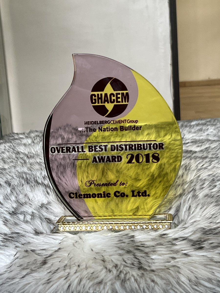 Flame-shaped acrylic trophy on a gold stand: GHACEM Overall Best Distributor Award 2018, presented to Clemonic Co. Ltd.