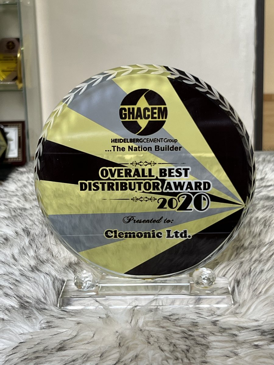 Round crystal plaque with yellow, black and grey rays: GHACEM Overall Best Distributor Award 2020, presented to Clemonic Ltd.
