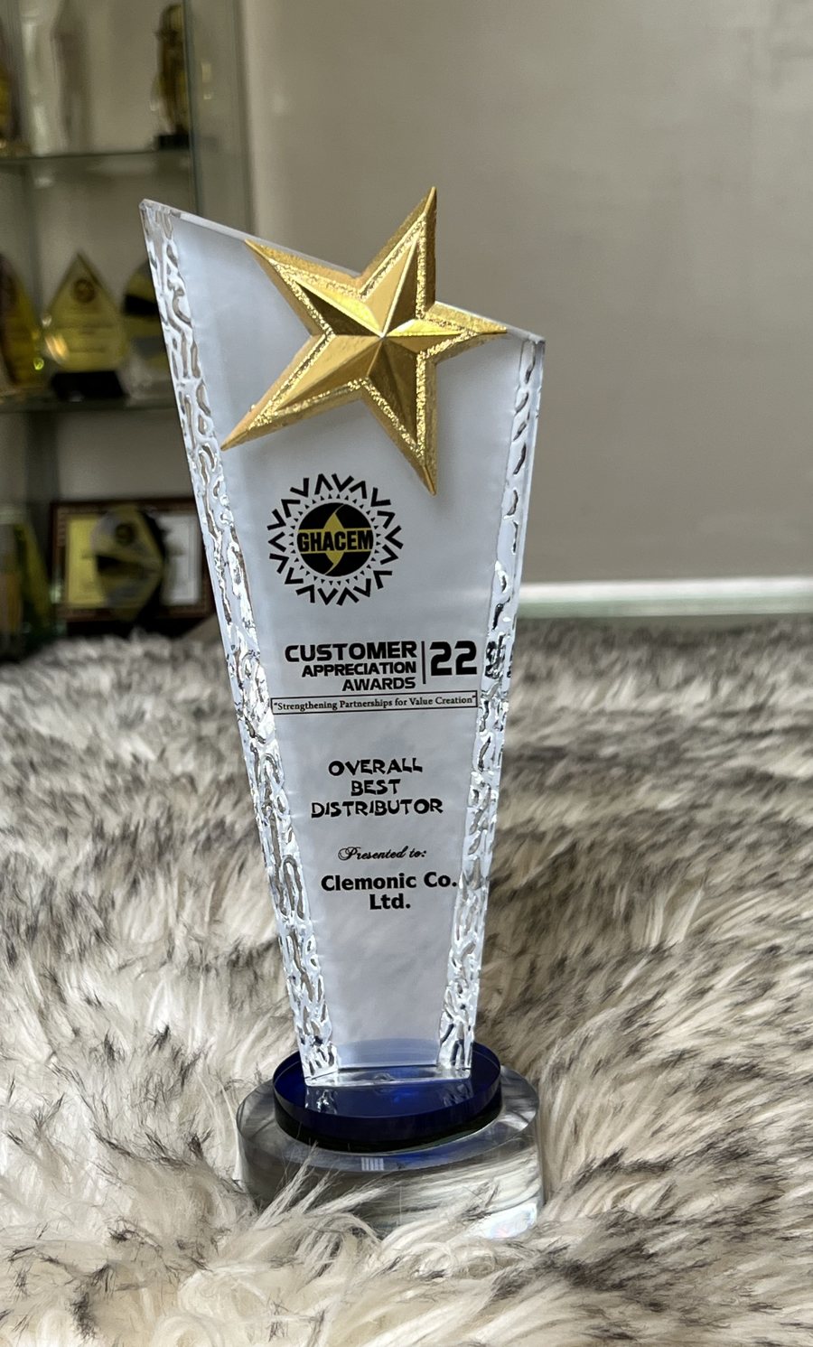 Crystal trophy with a gold star: GHACEM Customer Appreciation Awards 2022 — Overall Best Distributor, presented to Clemonic Co. Ltd.