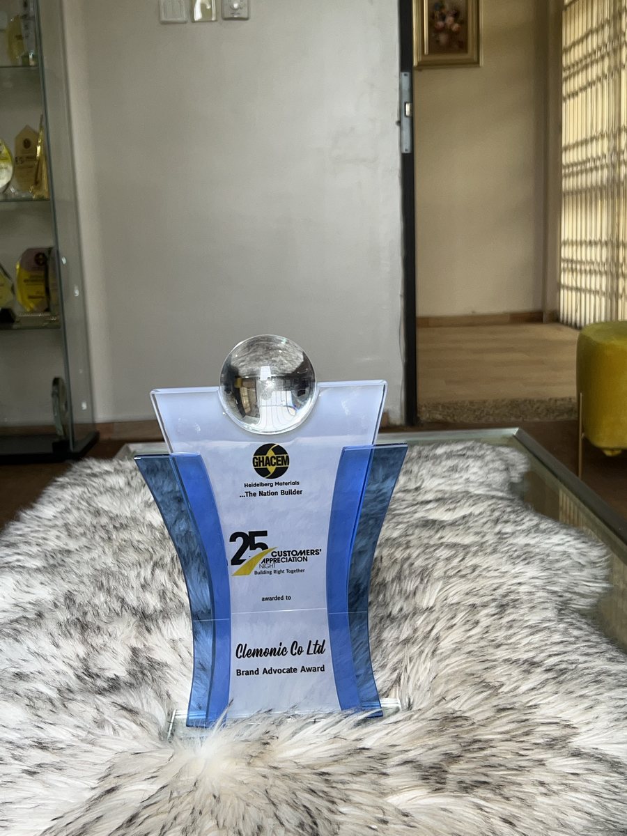 Frosted plaque between curved blue pillars with a crystal ball on top: GHACEM Customers' Appreciation Night 2025 — Brand Advocate Award, awarded to Clemonic Co Ltd
